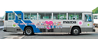 Mazda employee bus displaying human rights promotional slogans